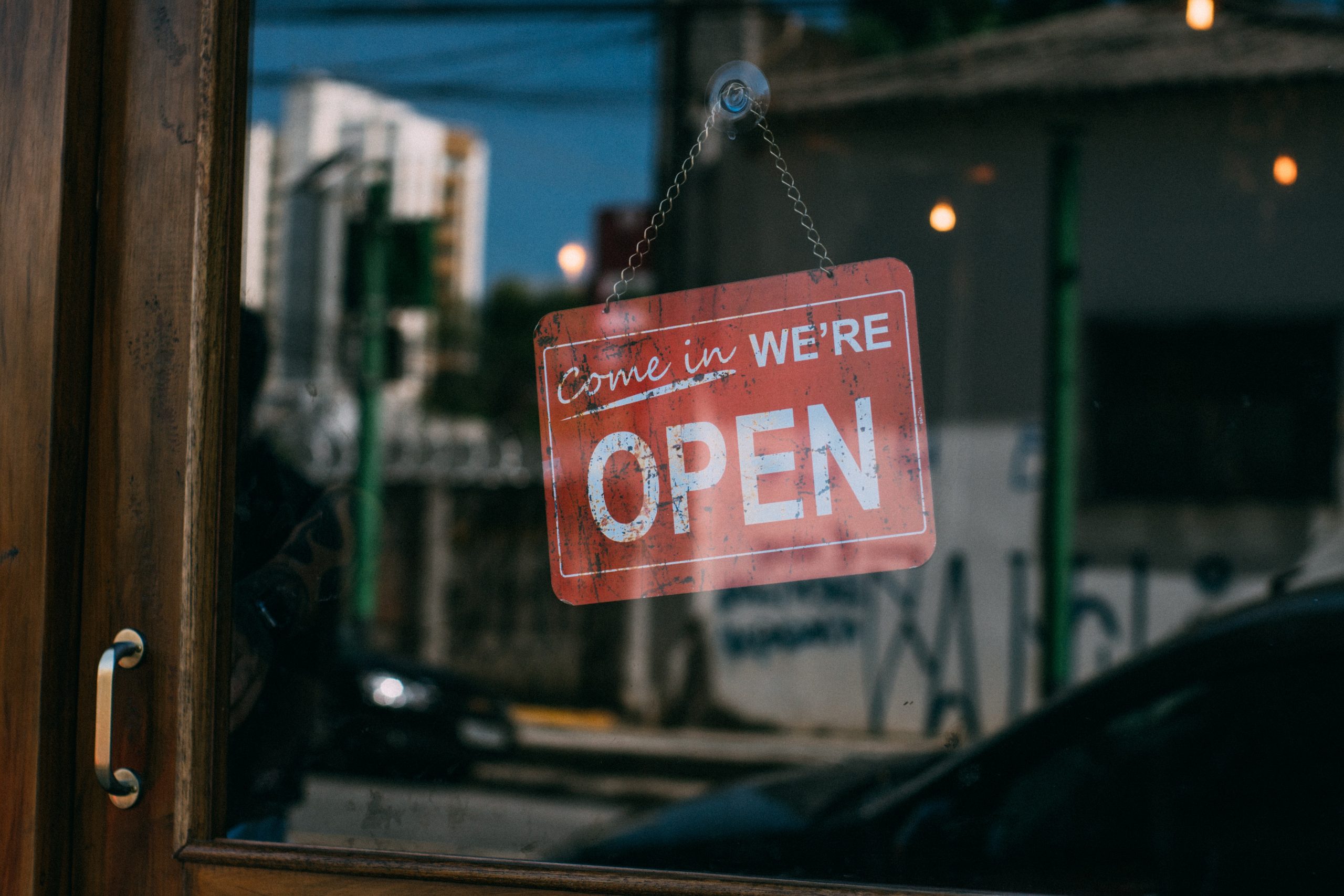 Come-in-we-are-open-sign-on-small-business-shop