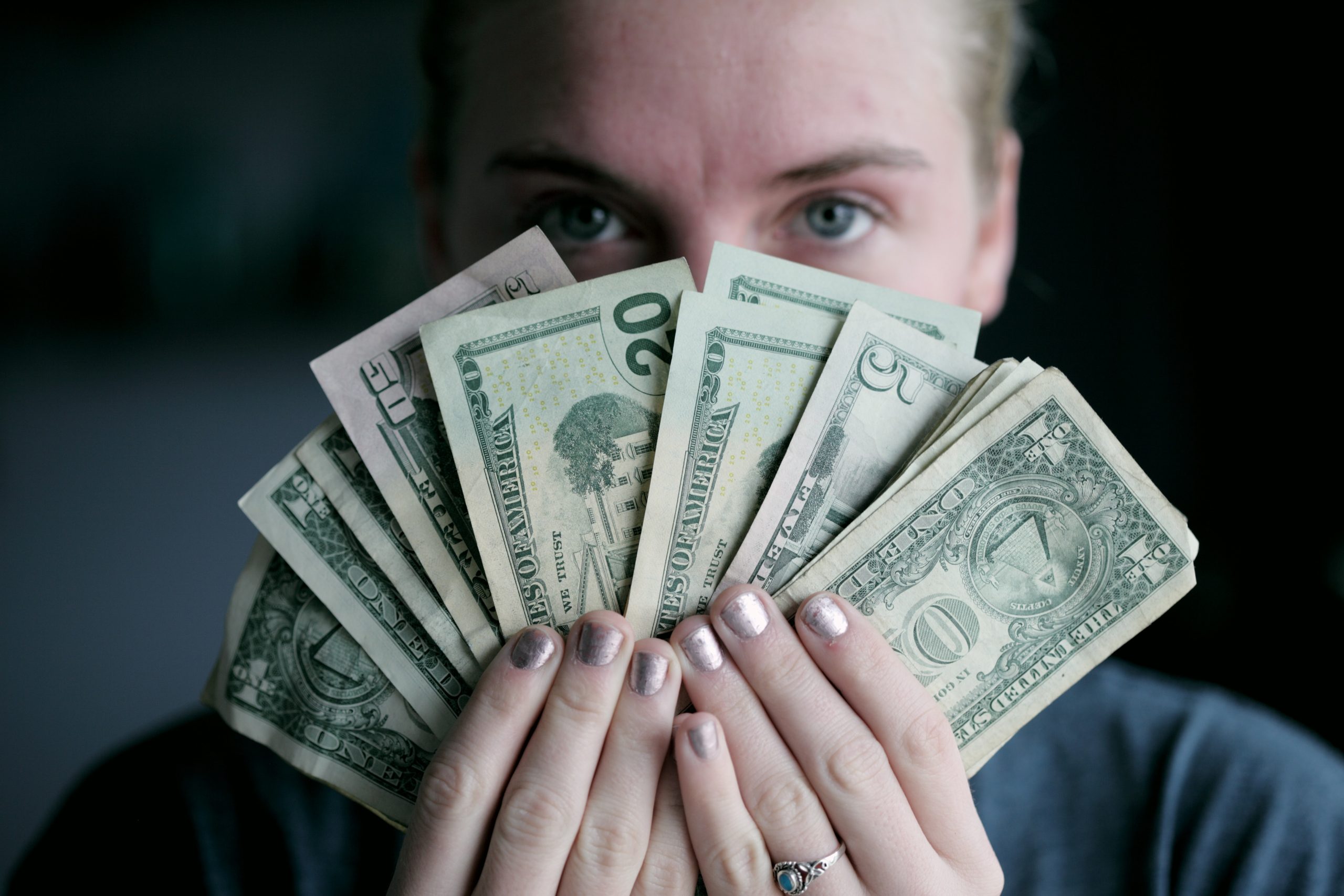 person-holding-dollar-bills