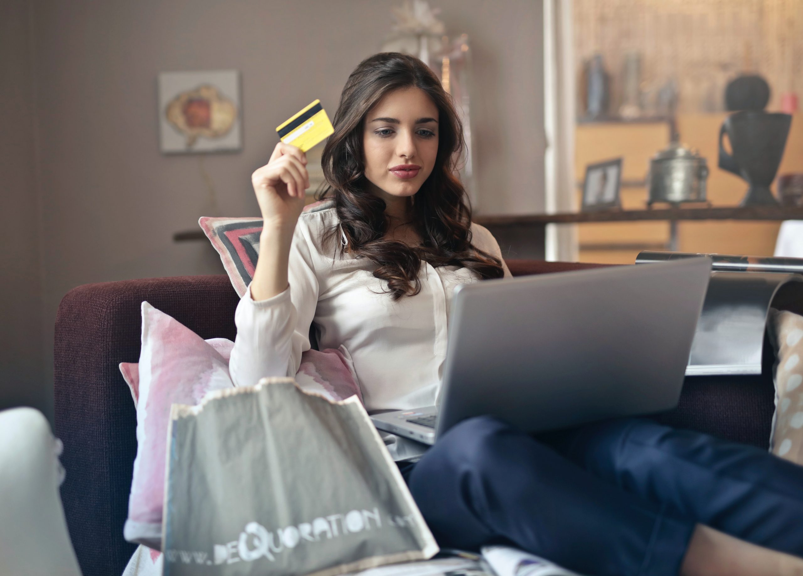 woman-holding-credit-card-while-shopping-online