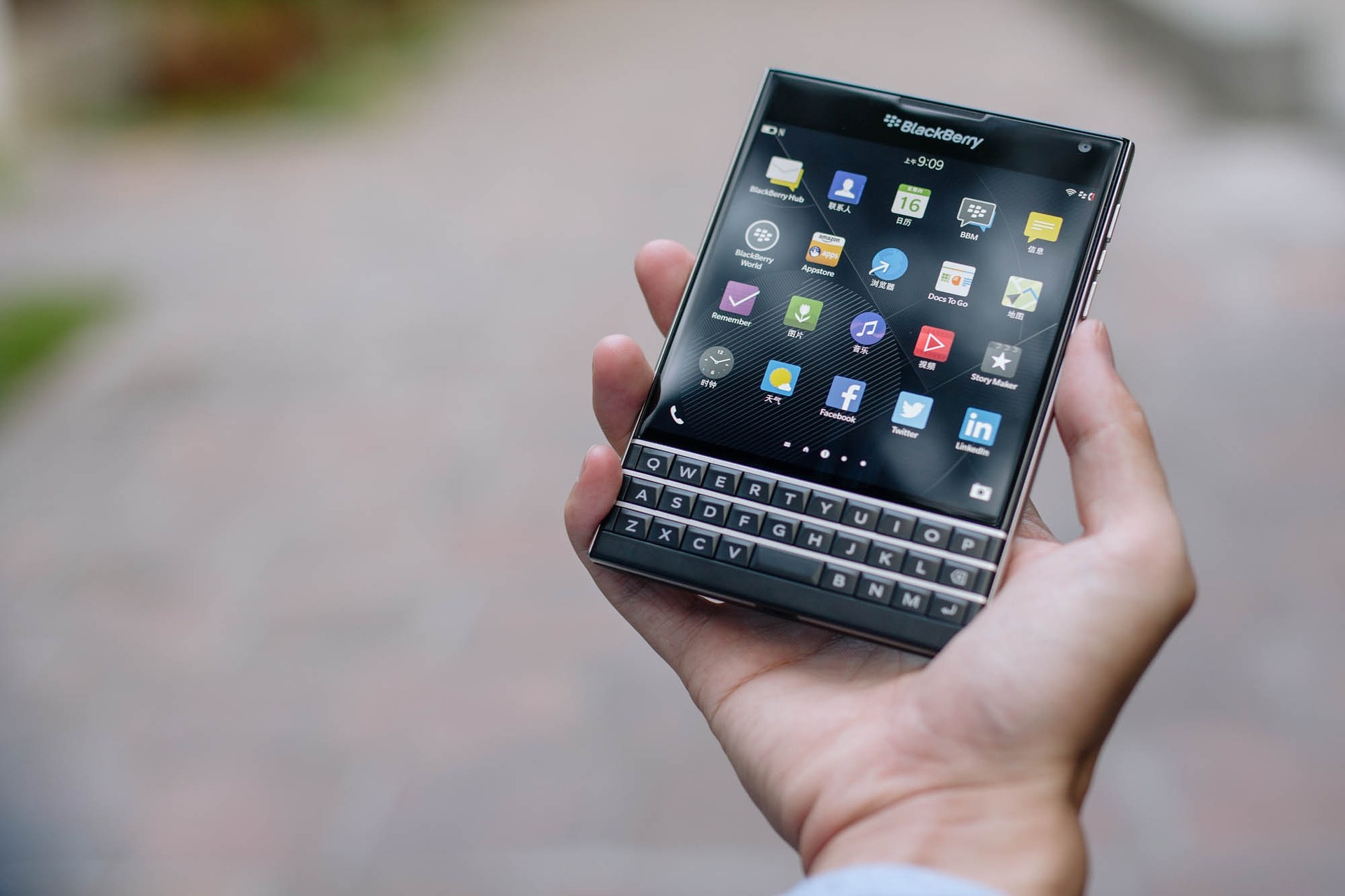 man-holding-blackberry-passport-smartphone-in-hand